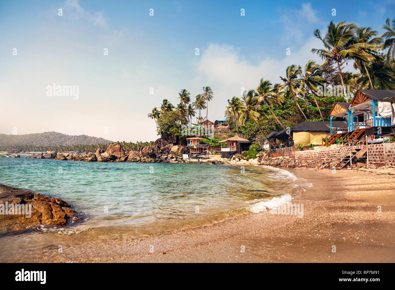 Cottages near lagoon in sunny day at Dreamy tropical Palolem beach in Goa, India Stock Photo