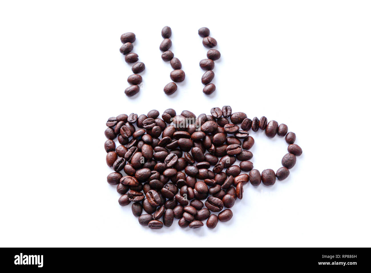 Roasted coffee beans scattered into a shape of a cup with rising steam. Isolated on white background. Stock Photo