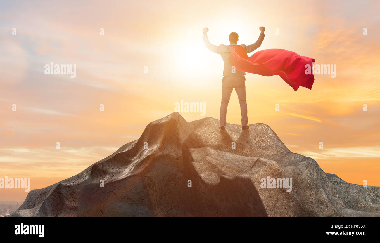 Superhero businessman on top of mountain Stock Photo - Alamy