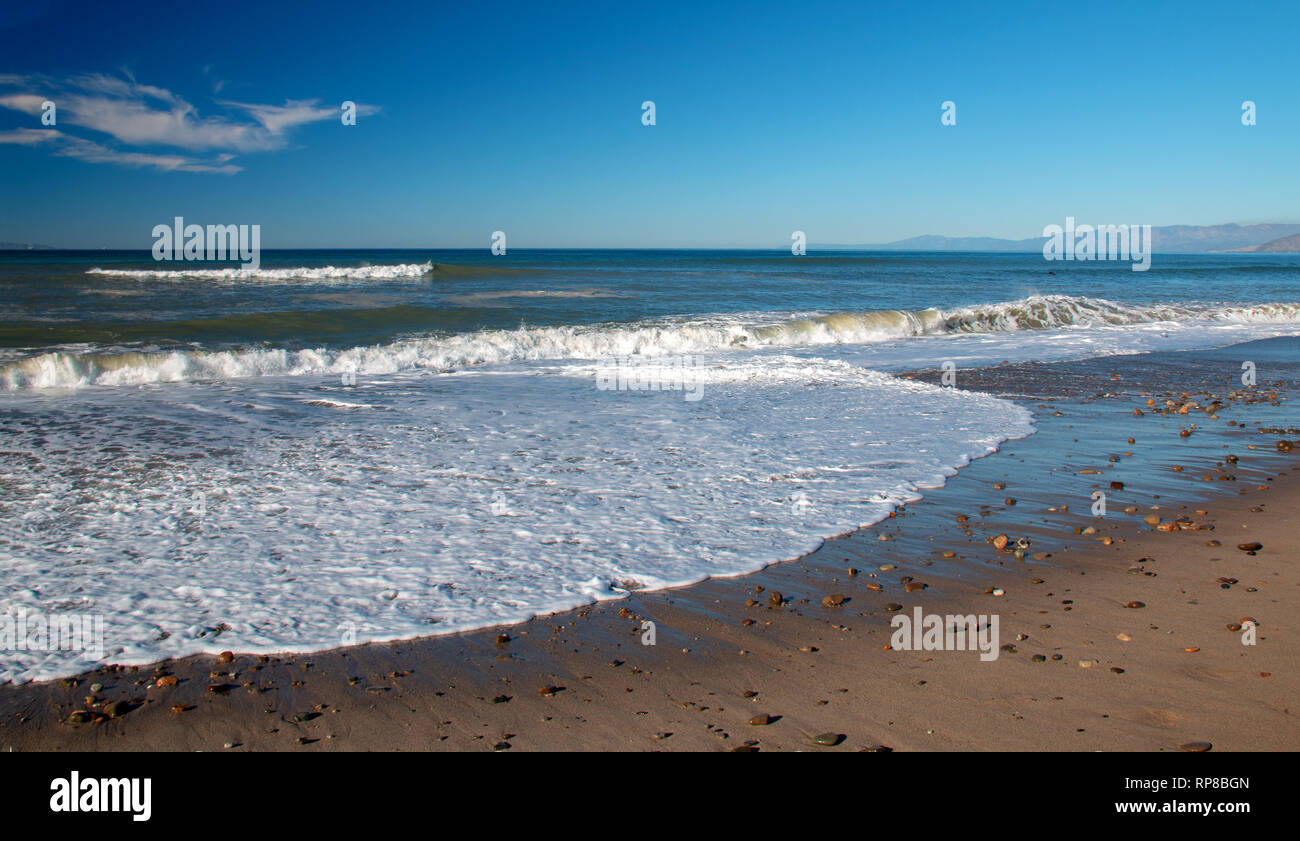 Seafoam wave patterns on Surfers Knoll beach in Ventura California United States Stock Photo