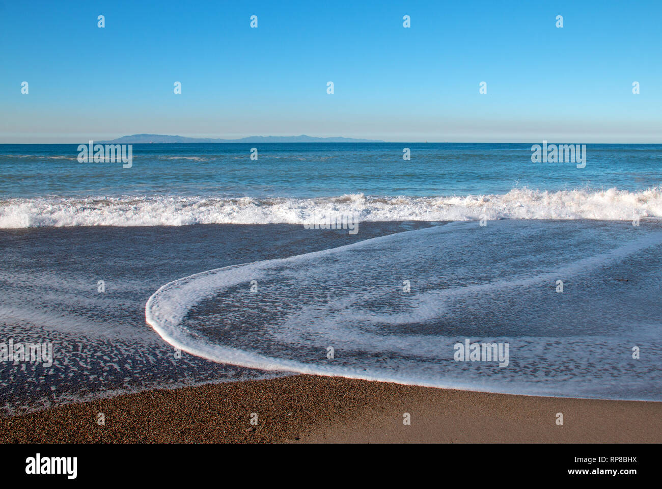 Seafoam wave patterns on Surfers Knoll beach in Ventura California United States Stock Photo