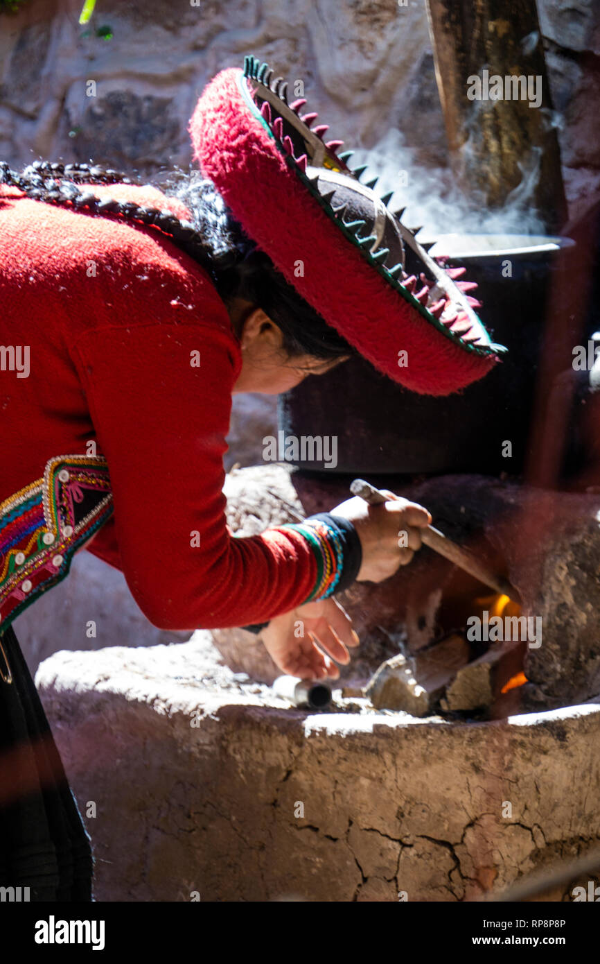 Woman in traditional dress prepares and dyes alpaca yarn in Sacred Valley, Cusco Region, Peru. Stock Photo