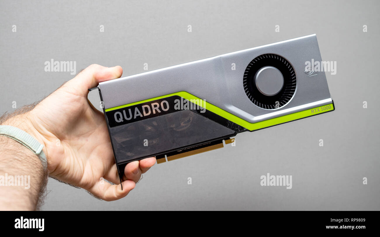 Paris, France - Feb 20, 2019: Man holding latest Nvidia Quadro RTX 5000 workstation professional video card GPU for professional CAD CGI scientific machine learning front view  Stock Photo