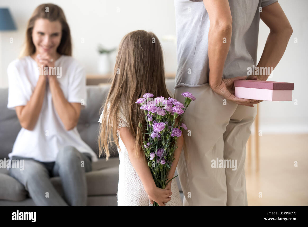 Loving daughter and grandmother preparing surprise for mother Stock Photo
