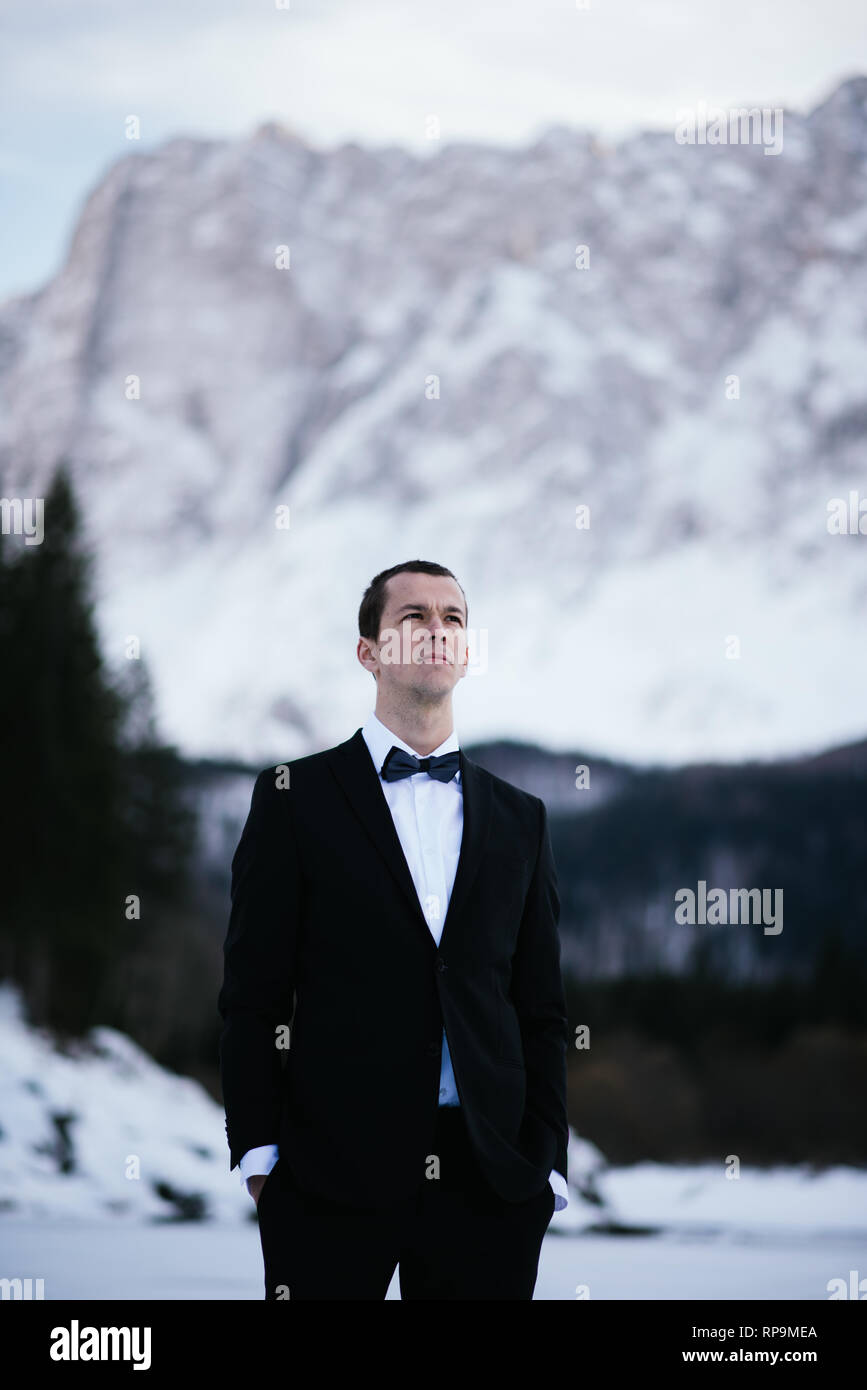 Groom posing in the mountains Stock Photo