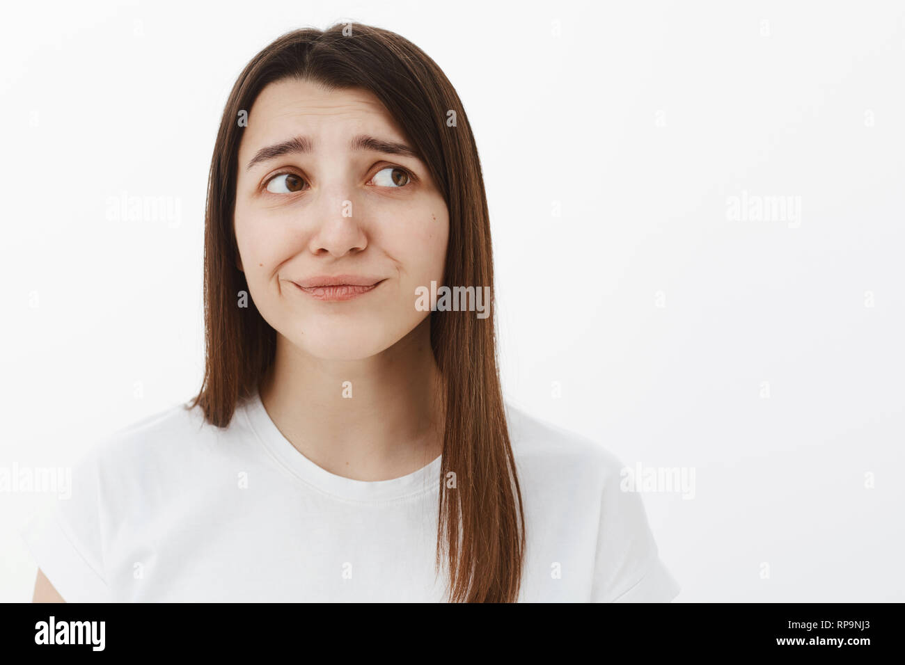 Girl expected different, being displeased and unimpressed smirking disappointed frowning and grimacing from dissatisfaction and aversion, looking away Stock Photo