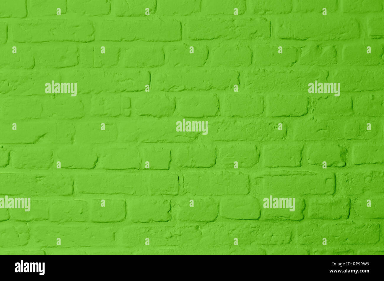 Pastell bright green colored brickstone wall, full frame, image background Stock Photo