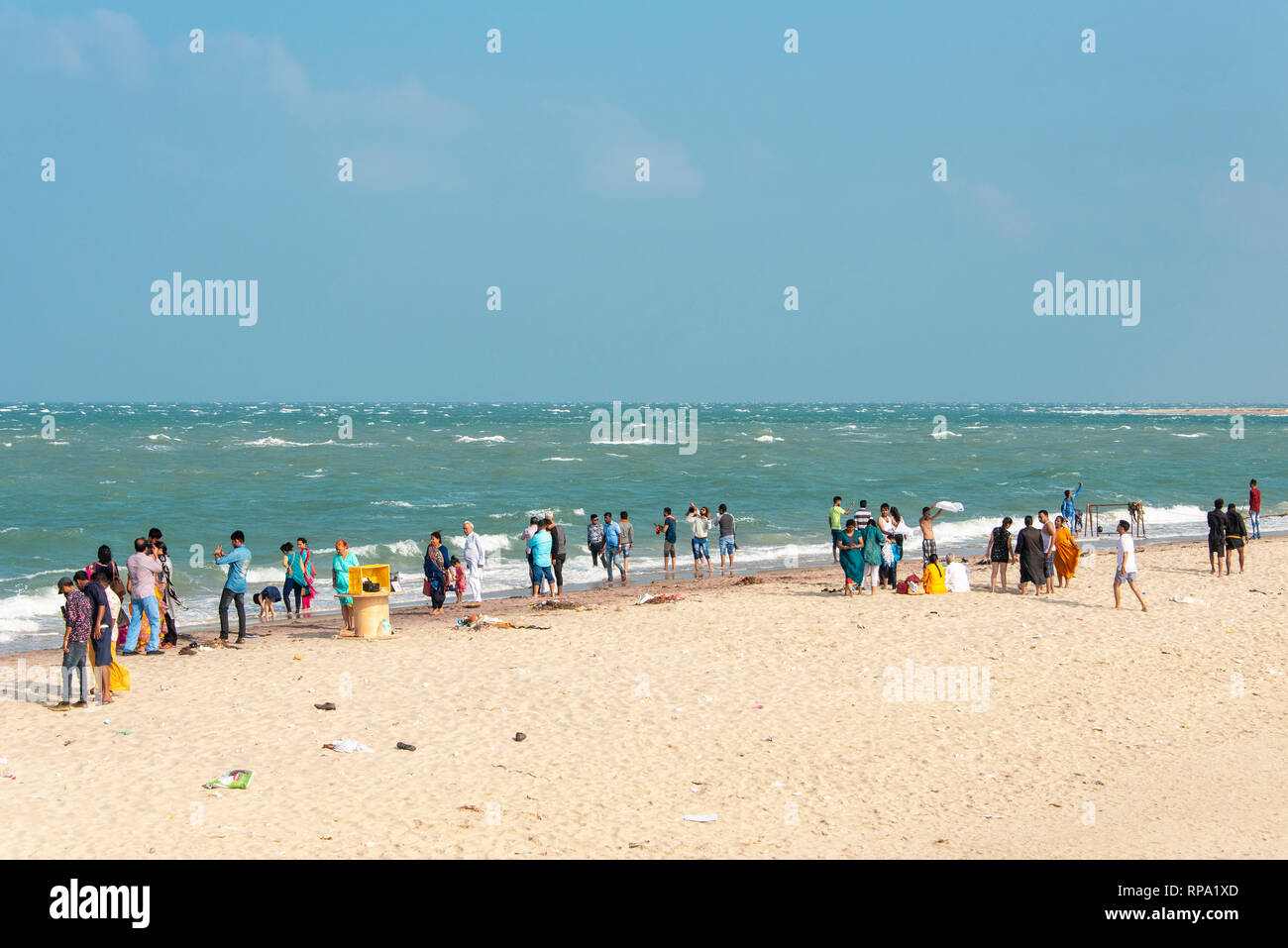 Tourists and local people at Dhanushkodi Beach Point on Pamban Island enjoy the view on a sunny day with blue sky. Stock Photo