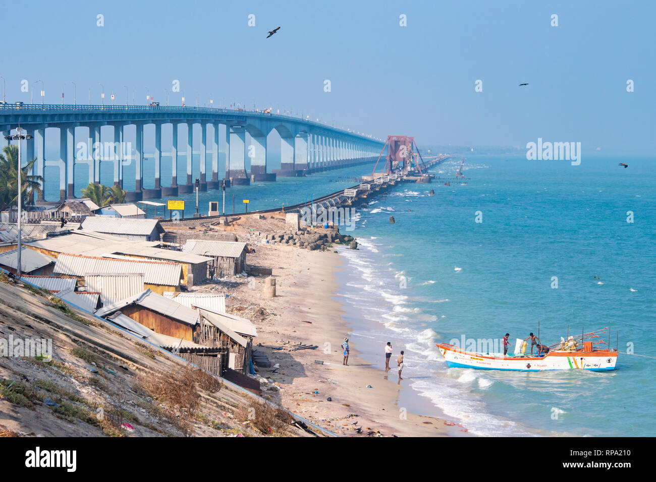 The Indira Gandhi Road Bridge and Pamban Bridge taken from the Rameswaram side on a sunny day with blue sky. Stock Photo