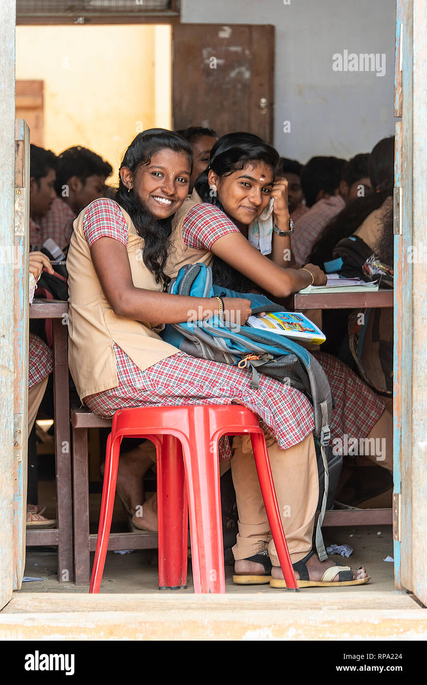 2 two young teenage Indian girls smile and pose for the camera during  lessons at a state school in India Stock Photo - Alamy