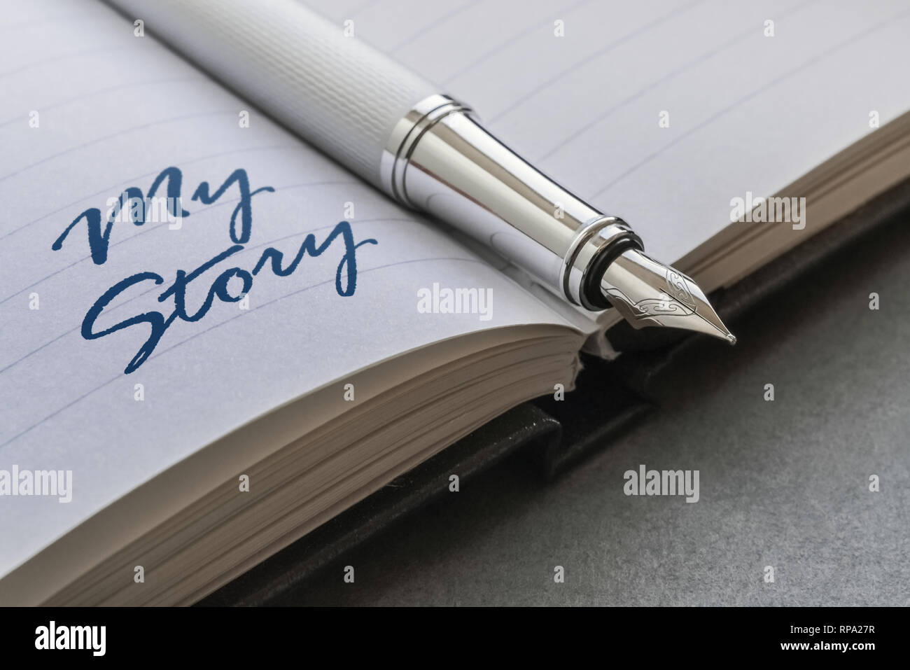 Fountain pen and text My Story written on an open notebook Stock Photo