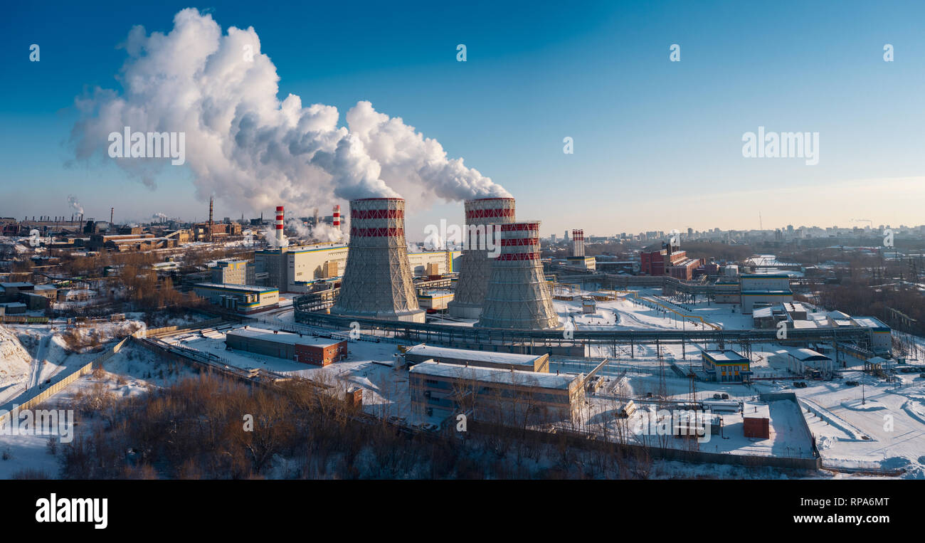 Panoramic view of heavy industry with detrimental impact on nature; CO2 emissions, toxic poisonous gases from chimneys; rusty dirty pipelines and clou Stock Photo