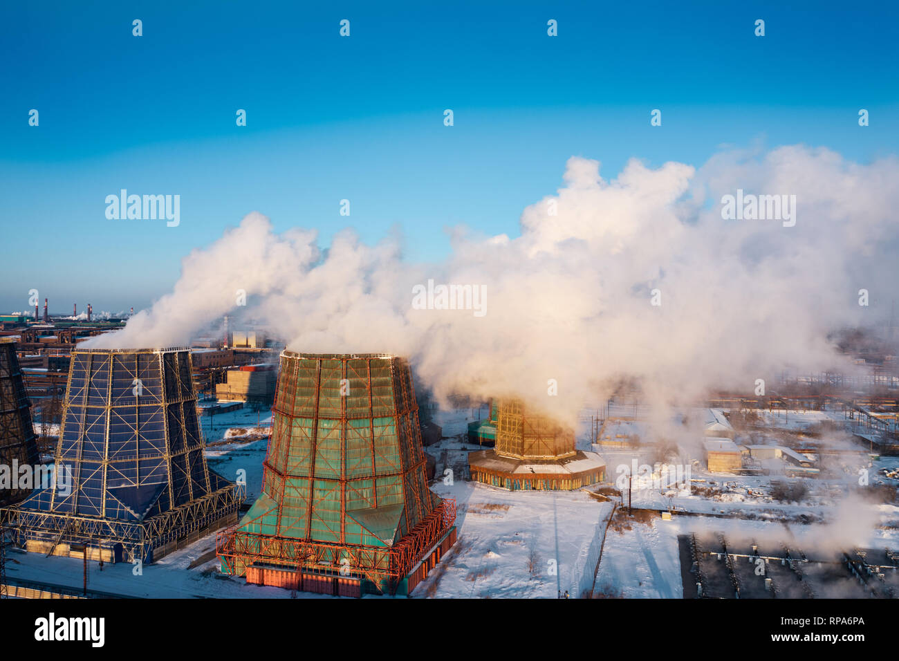 Panoramic view of heavy industry with detrimental impact on nature; CO2 emissions, toxic poisonous gases from chimneys; rusty dirty pipelines and clou Stock Photo