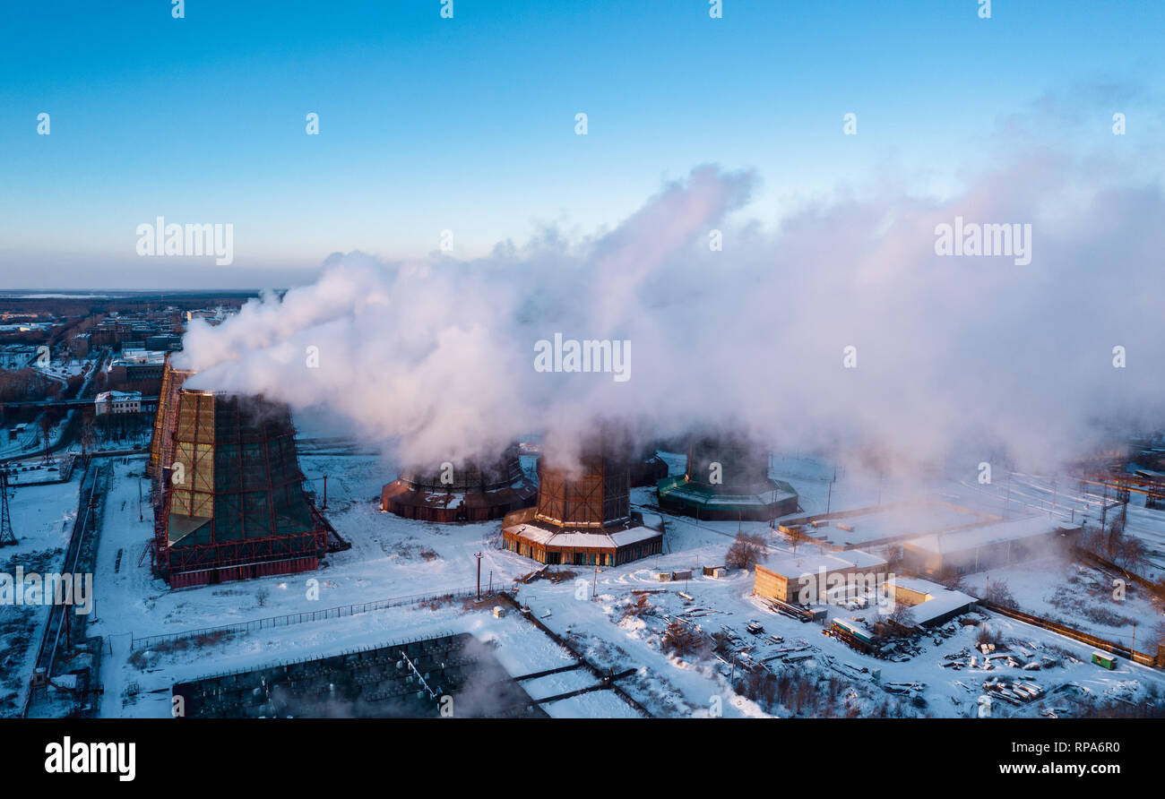 Panoramic view of heavy industry with detrimental impact on nature; CO2 emissions, toxic poisonous gases from chimneys; rusty dirty pipelines and clou Stock Photo