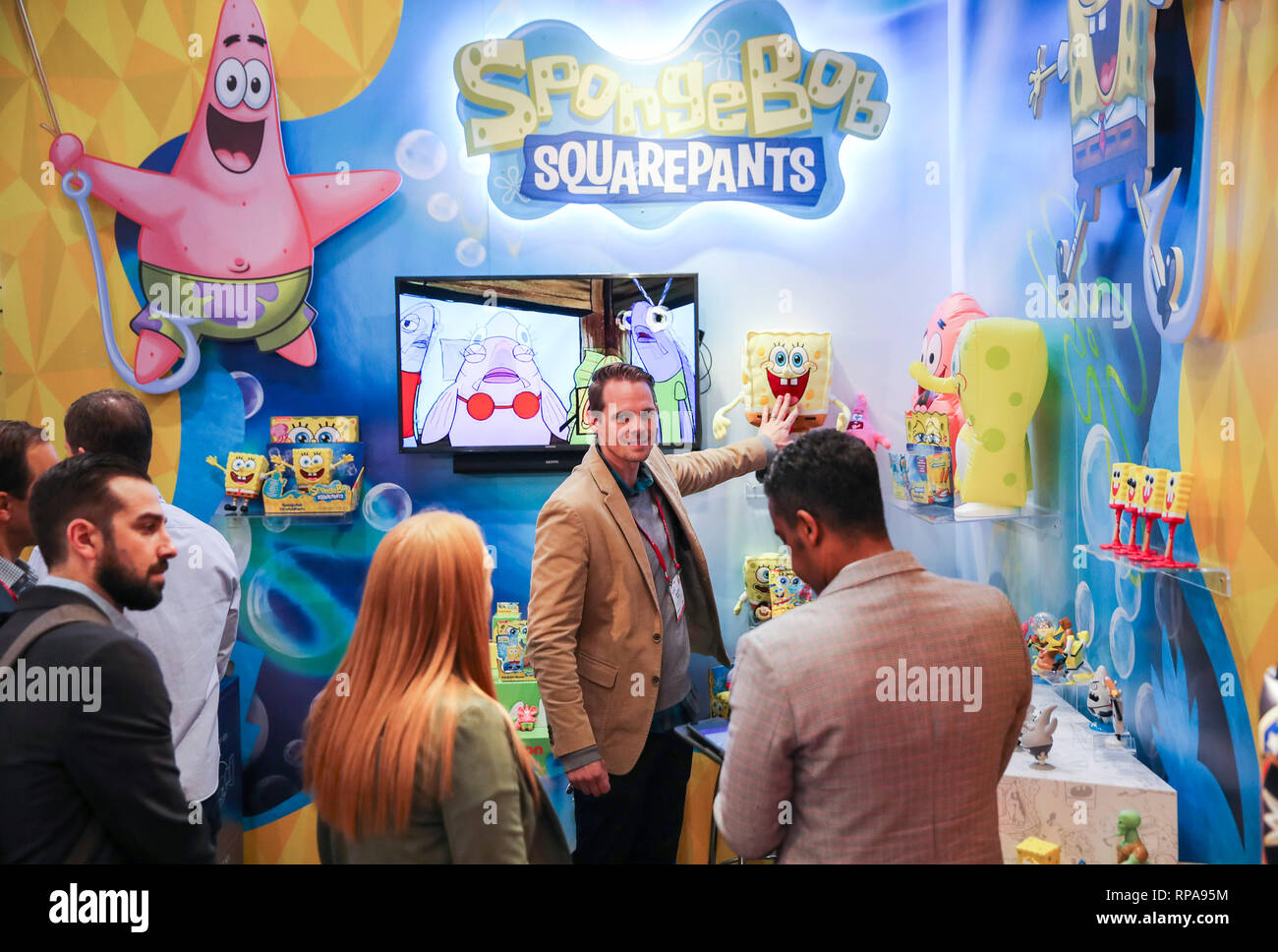 (190221) -- NEW YORK, Feb. 21, 2019 (Xinhua) -- Visitors look at toy products of SpongeBob at the booth of Alpha Group Co., Ltd., a major animation, toy and entertainment player from Guangdong Province in southern China, during the 116th Annual North American International Toy Fair at the Jacob K. Javits Convention Center in New York, the United States, on Feb. 19, 2019. Chinese toy manufacturers, which produce around 75 percent of global toys each year, are rising up the value chain from the original role as contract manufacturers to designers and makers of their own brands. (Xinhua/Wang Ying Stock Photo