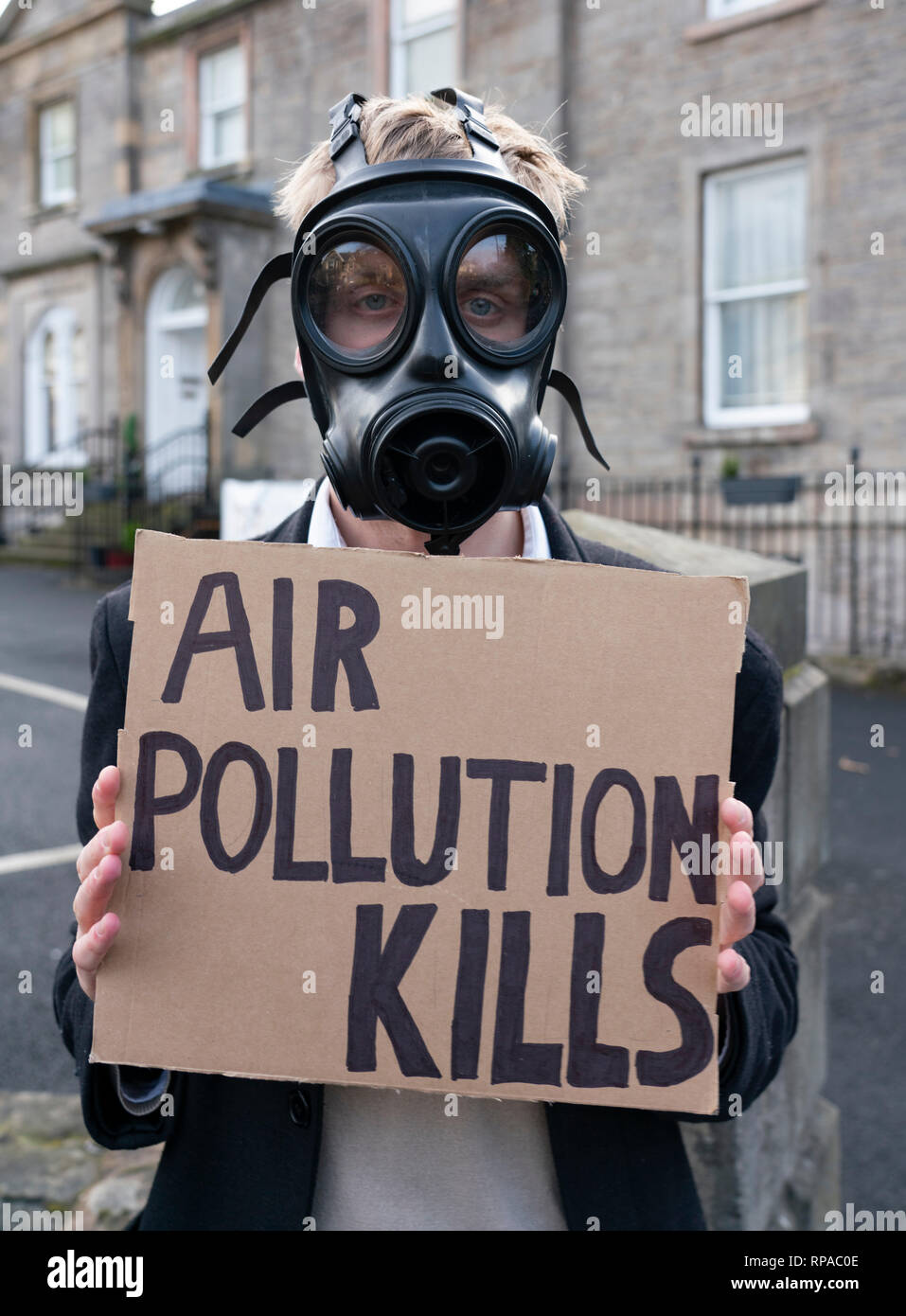 Edinburgh, Scotland, UK. 21st Feb, 2019. Anti air pollution campaigners stage protest at unveiling of Scottish Conservatives' Ad Van against the proposed Car Park Tax. Jackson Carlaw MSP and Miles Briggs MSP unveiled an Ad Van at an Edinburgh care home today before it travels across the central belt of Scotland to workplaces that are set to be hit by the proposed Car Park Tax which is to be voted through the Scottish Parliament by the SNP and Green parties. Credit: Iain Masterton/Alamy Live News Stock Photo