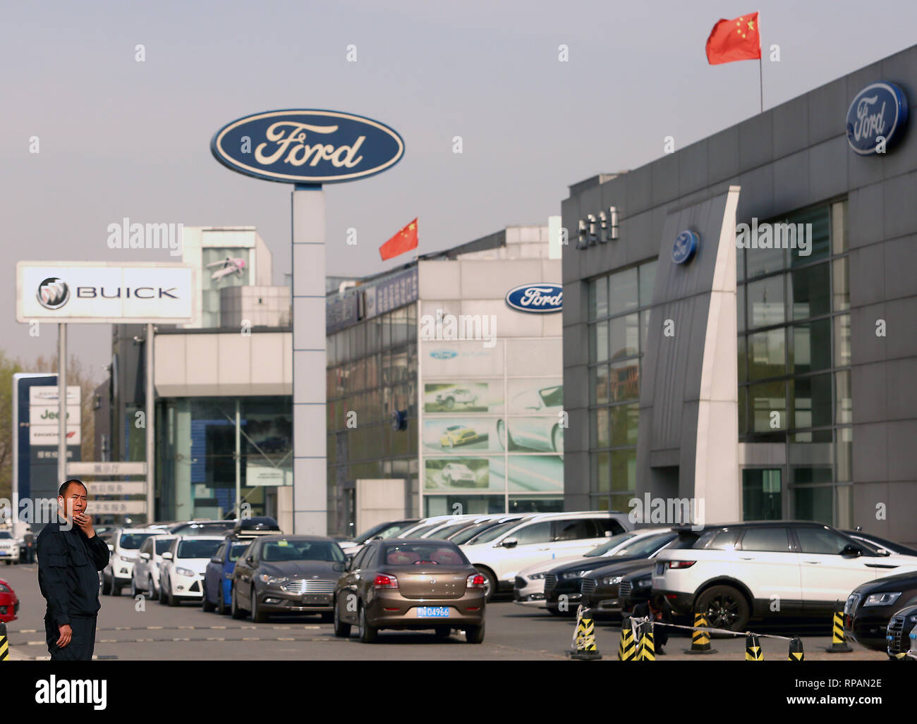 April 8, 2018 - Beijing, China - Chinese national flags fly over Ford and Buick showrooms in Beijing on April 8, 2018. China hit back at the U.S. with proposed tariffs on $50 billion worth of goods - American cars, soybeans, whiskey and other goods.. (Credit Image: © Todd Lee/ZUMAprilESS.com/ZUMA Wire) Stock Photo
