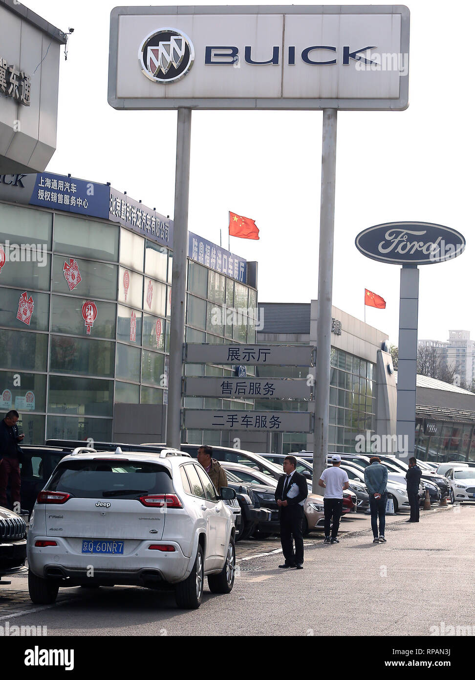 April 8, 2018 - Beijing, China - Chinese national flags fly over Ford and Buick showrooms in Beijing on April 8, 2018. China hit back at the U.S. with proposed tariffs on $50 billion worth of goods - American cars, soybeans, whiskey and other goods.. (Credit Image: © Todd Lee/ZUMAprilESS.com/ZUMA Wire) Stock Photo