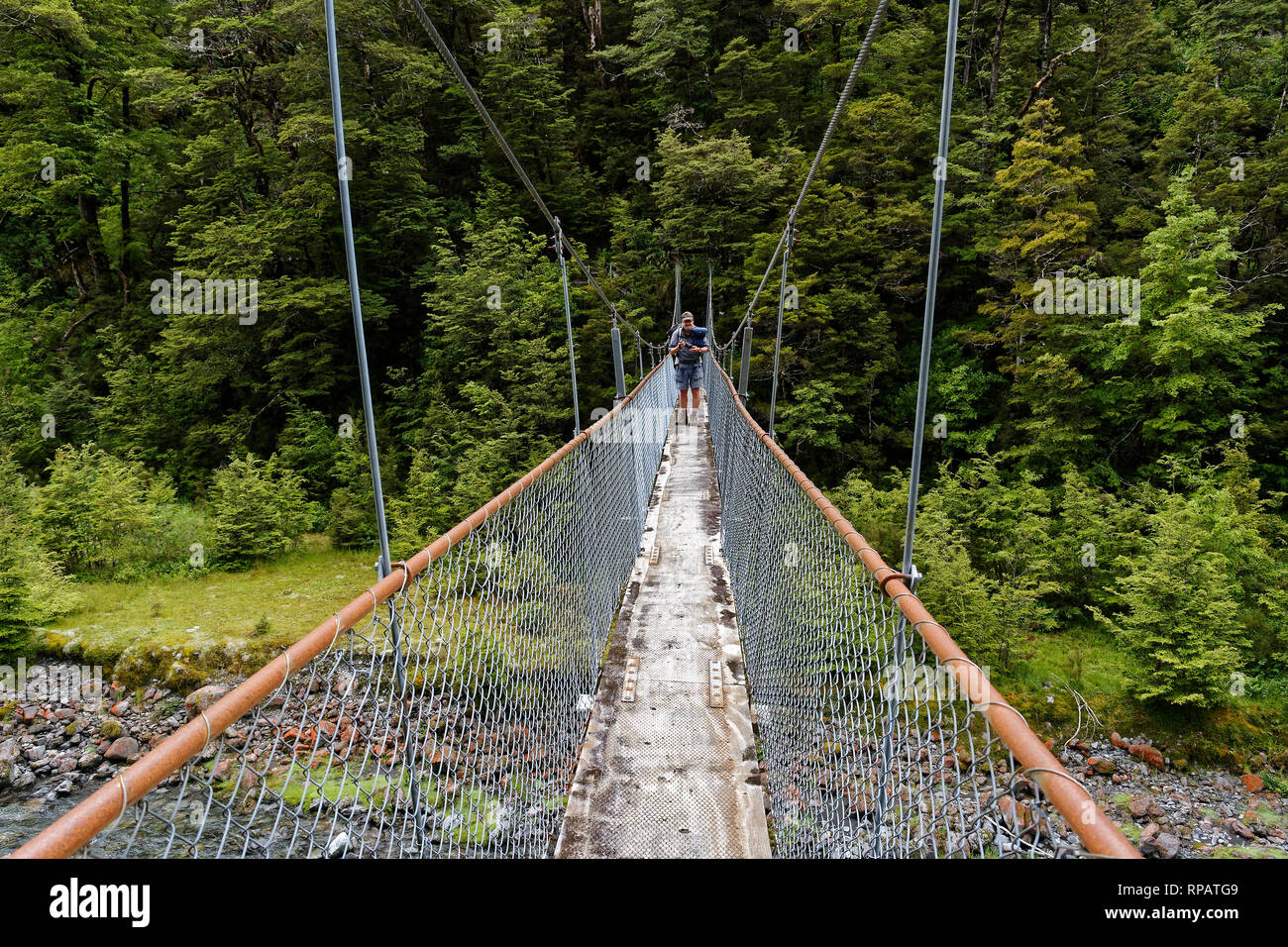 A typical hiking bridge, a suspended swing bridge over a river on the St James Walkway Stock Photo