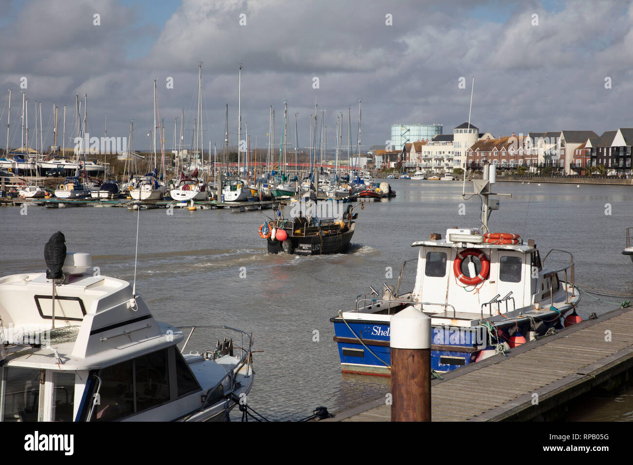 Fishing boat sailing up River Arun, Littlehampton, West Sussex Stock