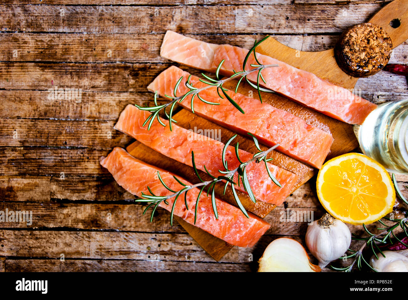 Salmon fish meat with cooking ingredients on a cutting board Stock ...