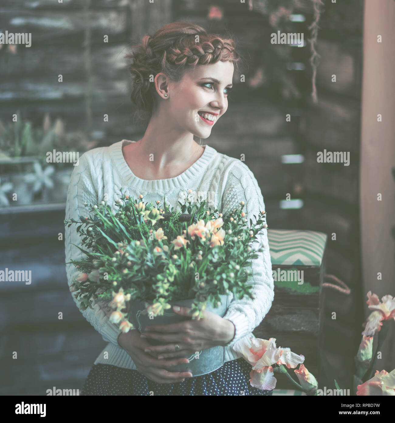 portrait of a beautiful happy young woman with a bouquet of flowers ...
