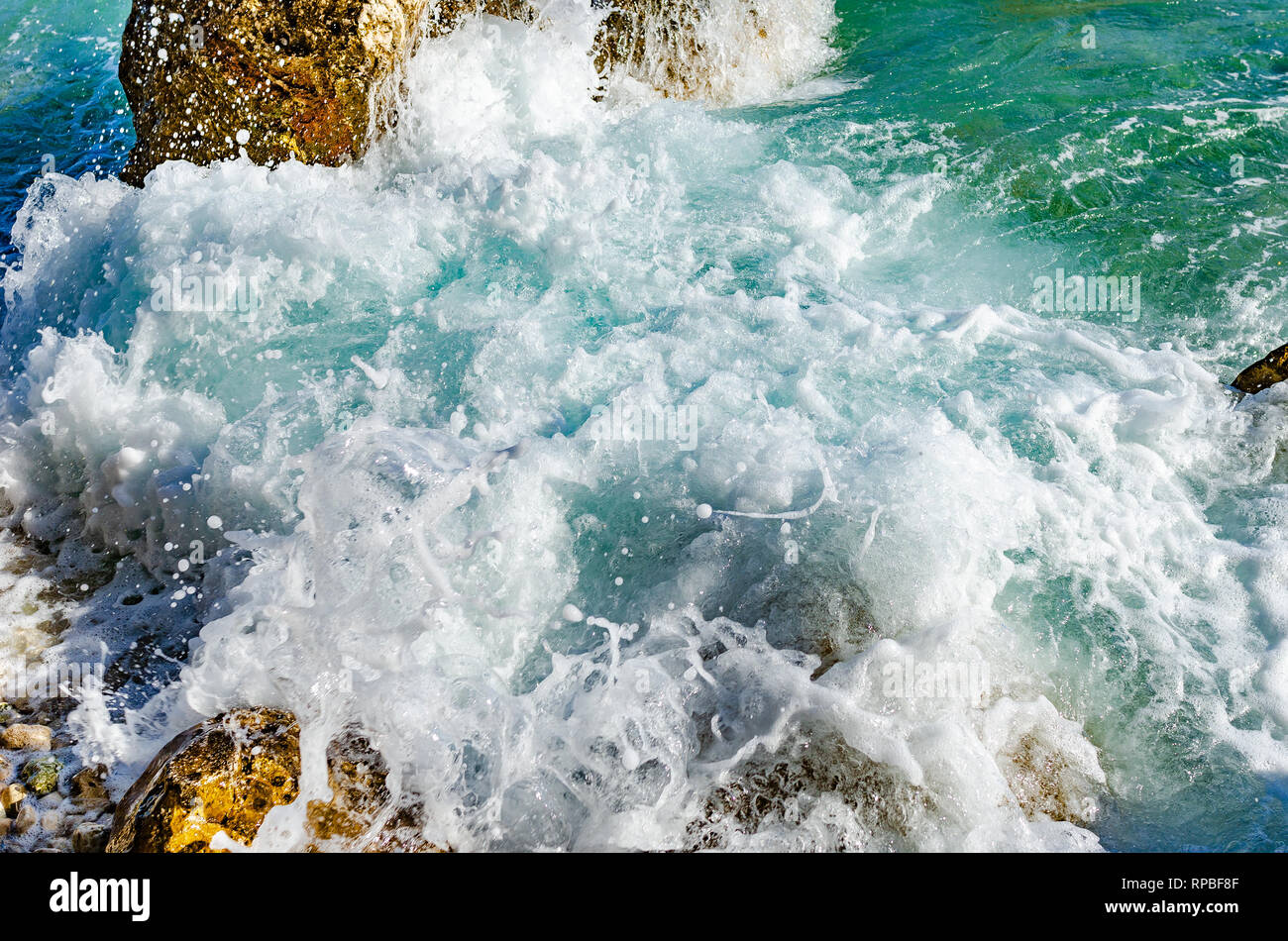 Waves beat on the coastal stones. Stock Photo