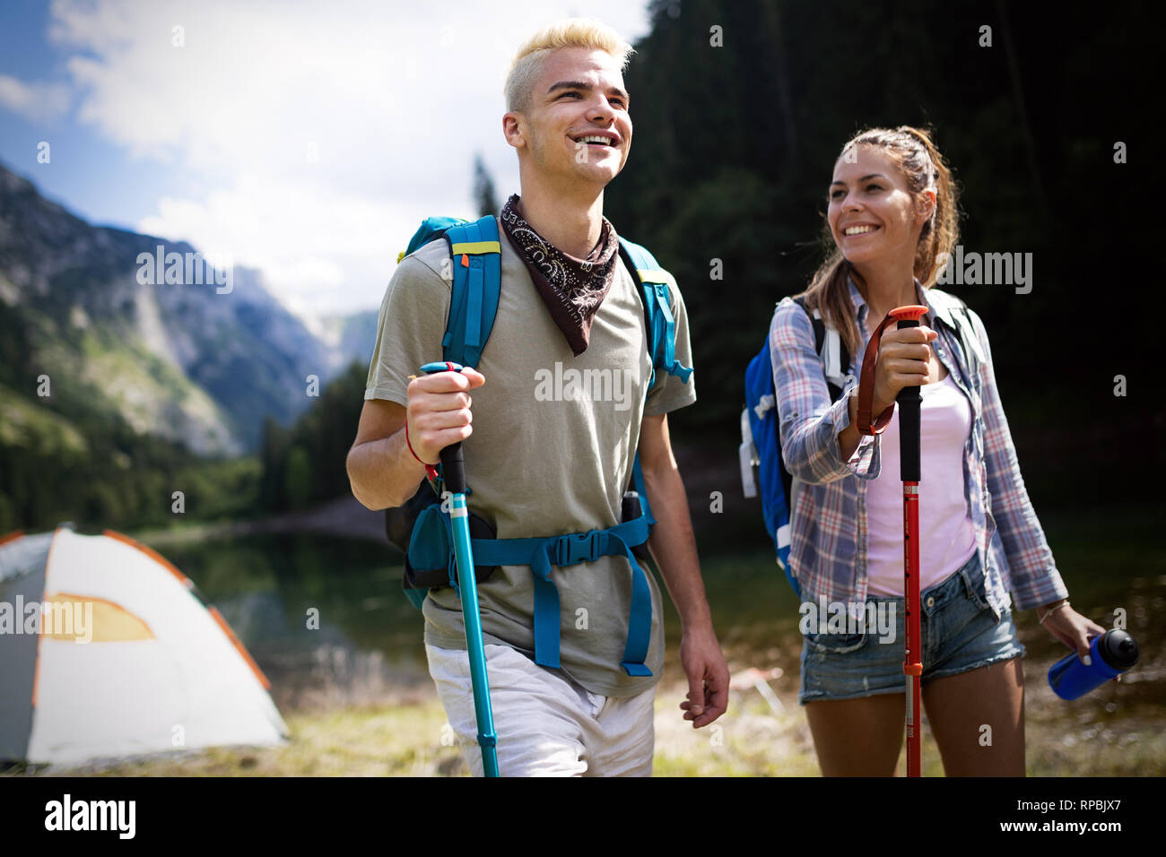 Group of friends hikers walking on a mountain at sunset Stock Photo - Alamy