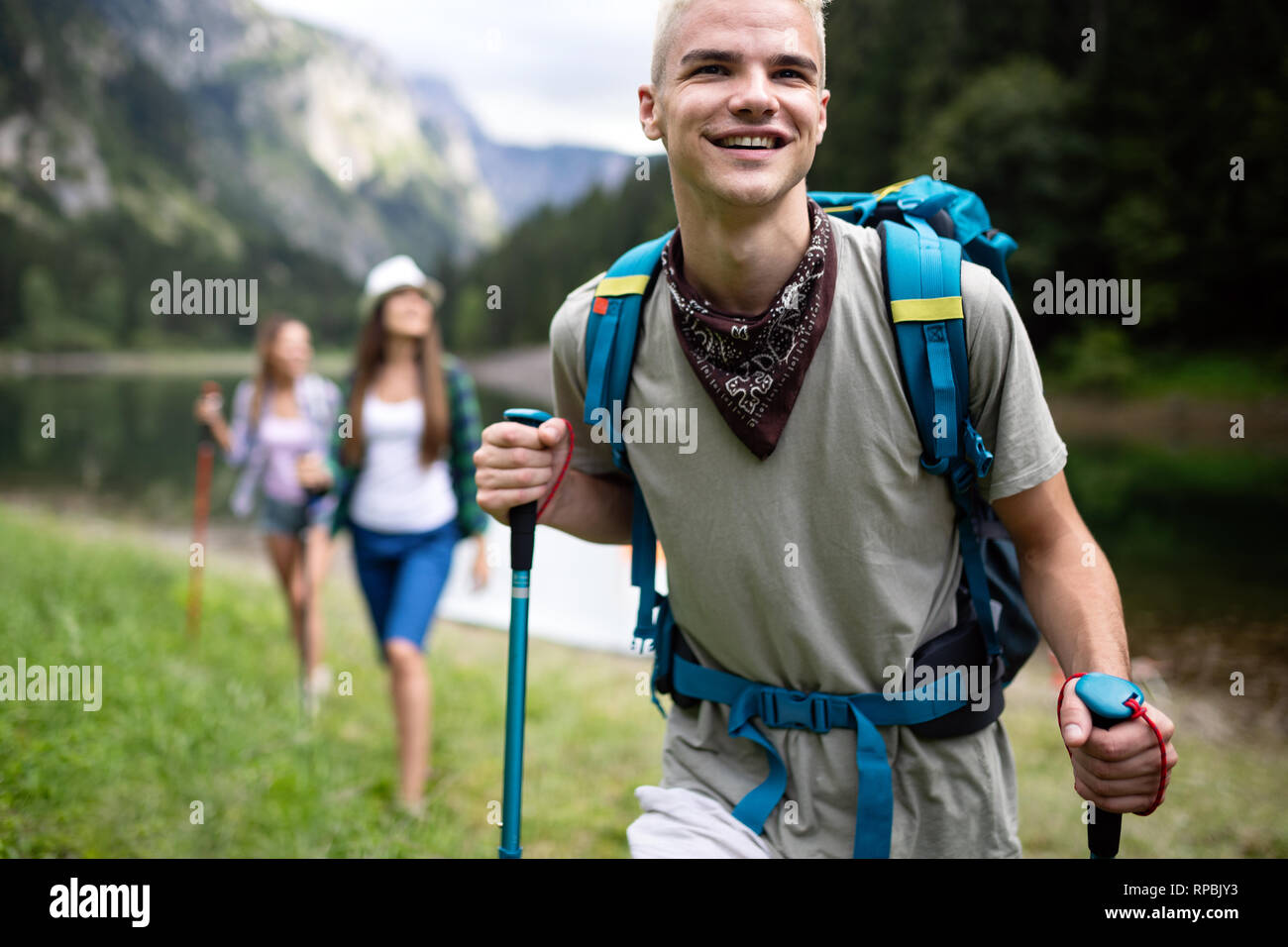 Group of young friends hiking in countryside. Multiracial happy people travelling in nature Stock Photo