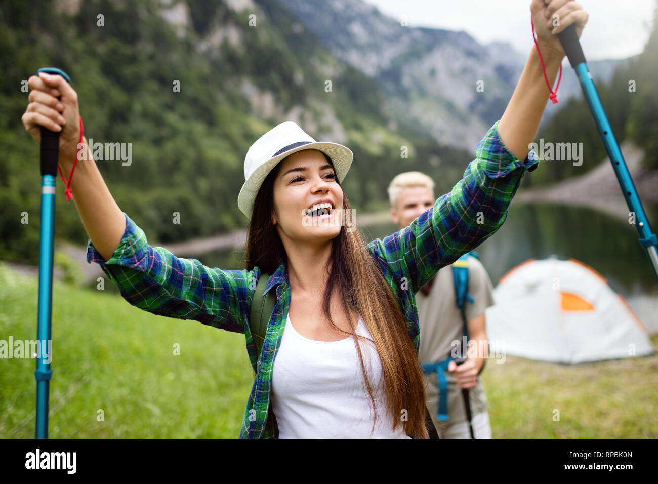 Group of young friends hiking in countryside. Multiracial happy people travelling in nature Stock Photo