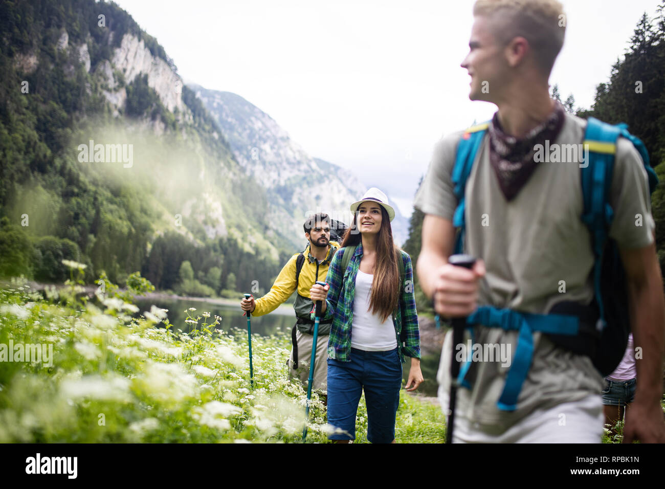 Group of young friends hiking in countryside. Multiracial happy people travelling in nature Stock Photo