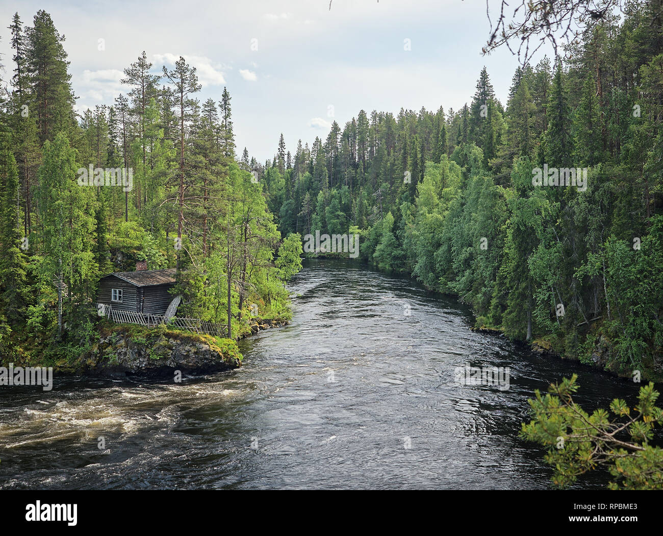 Finnish landscape with an old fisherman's hut along the Oulankajoki river at the Oulanka National Park in Kuusamo, Finland. Scenic view of the norther Stock Photo