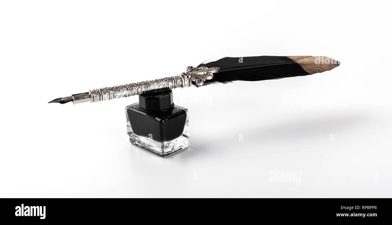 feather quill pen and ink bottle isolated on white background Stock