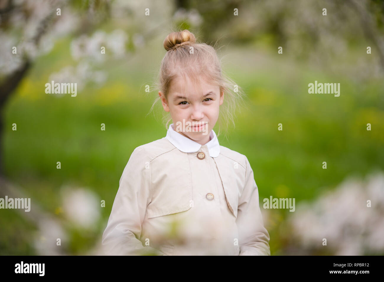 Serious Female Kid With Blonde Hair And Blowm Eyes In The Light