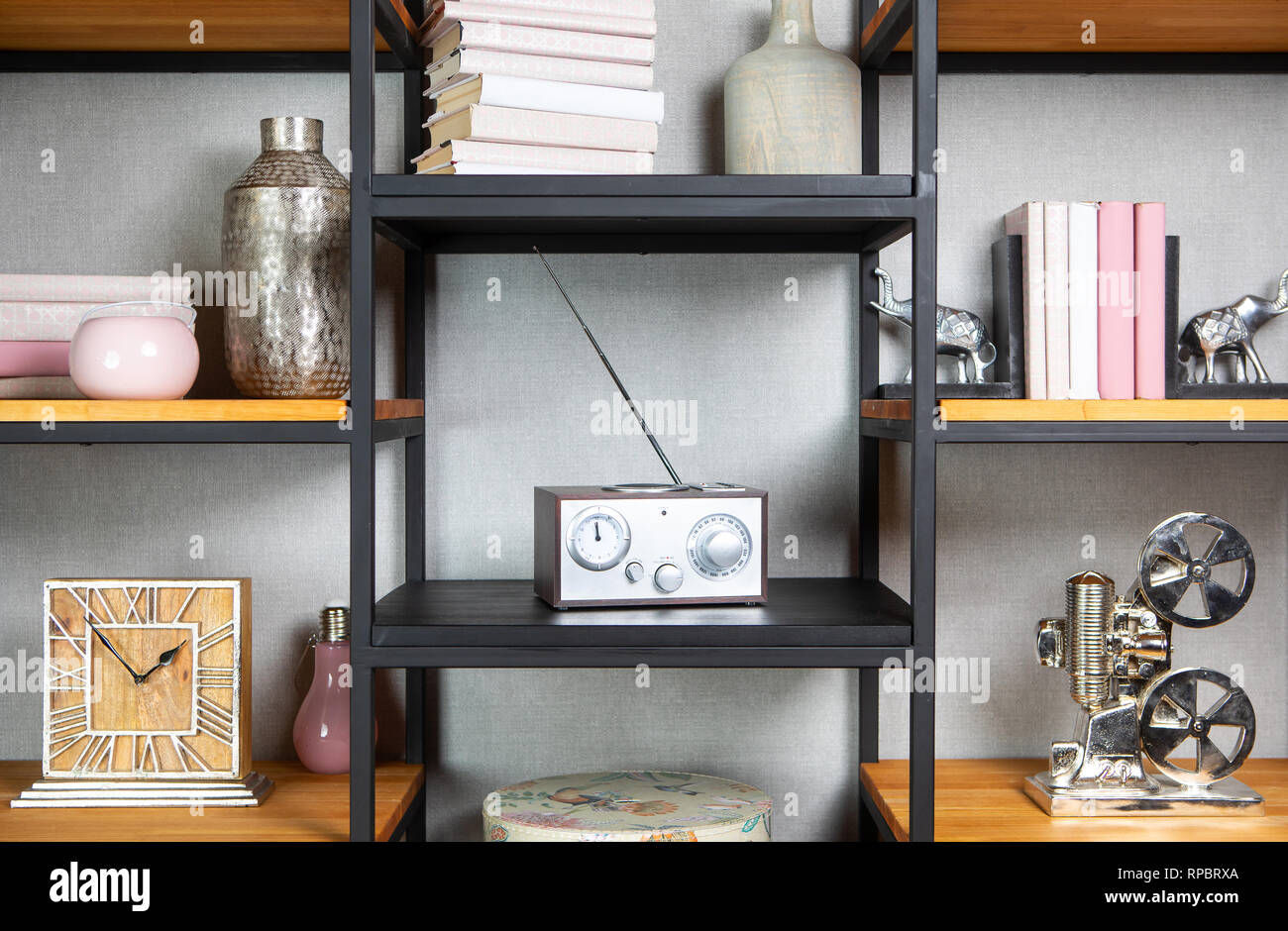 Compact radio on bookshelf in vintage living room interior Stock Photo