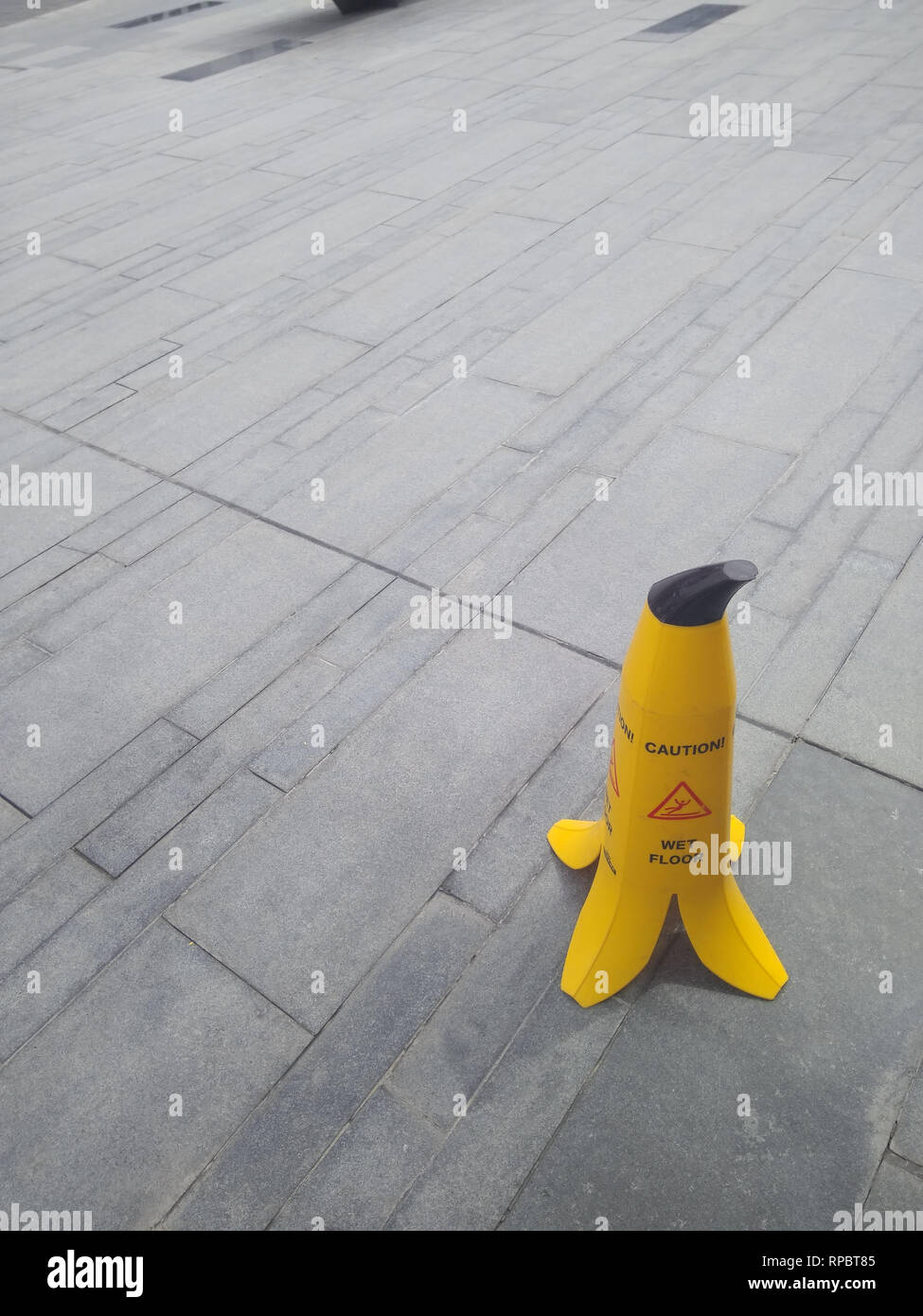 Dubai-Slippery floor banana warning sign on the sidewalk Stock Photo