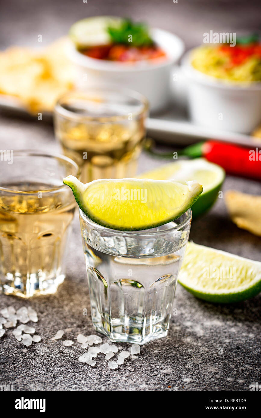 Shots of silver and gold tequila Stock Photo Alamy