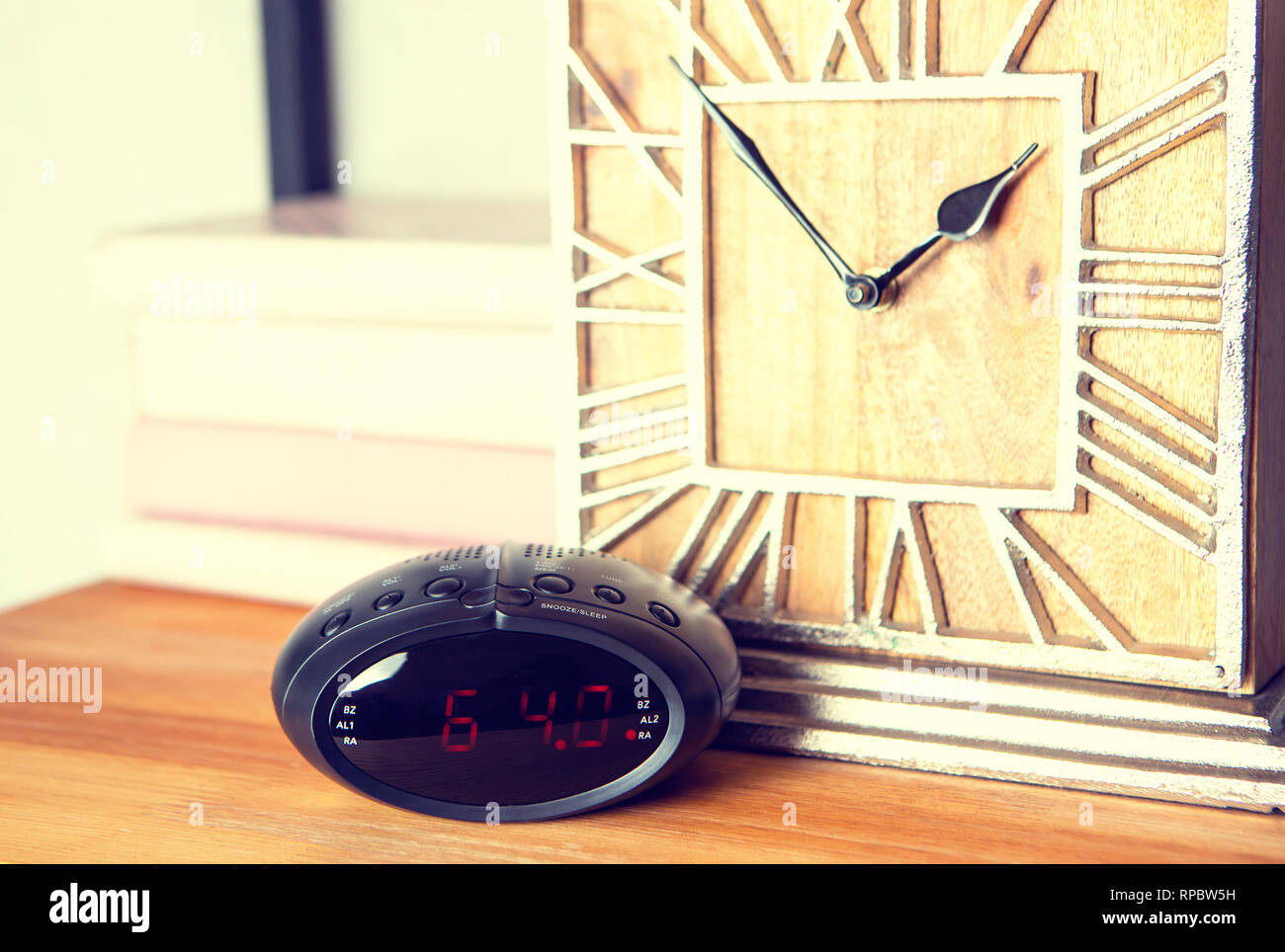 Electronic alarm clock in the vintage interior of the room on the shelf