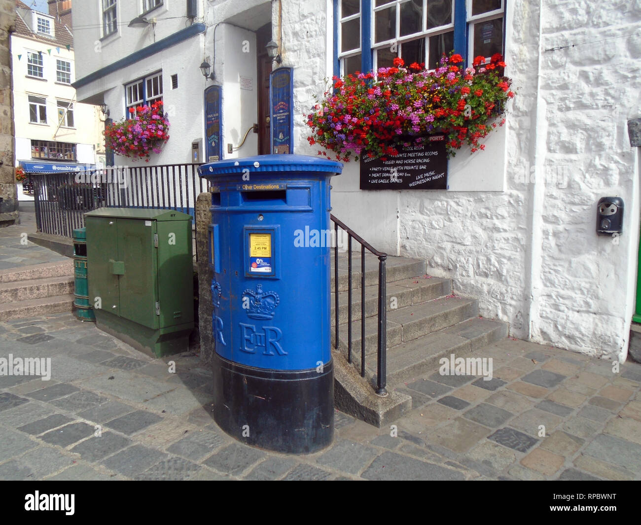 Blue Post Box Outside the Albion Traven in Church Square, St Peter Port Guernsey, Channel Islands.UK. Stock Photo