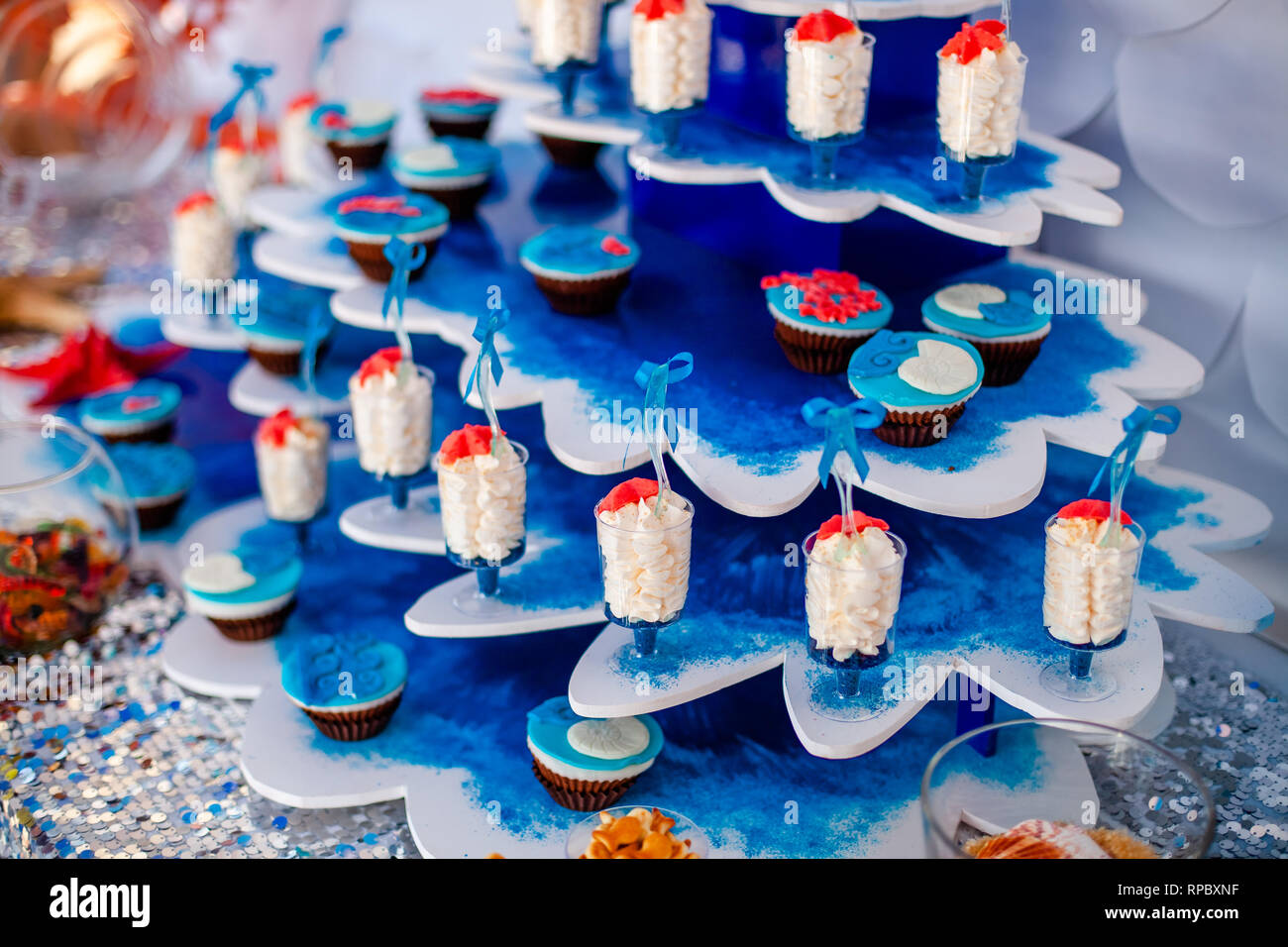 Desserts with whipped cream and sea star decor. Candy bar for