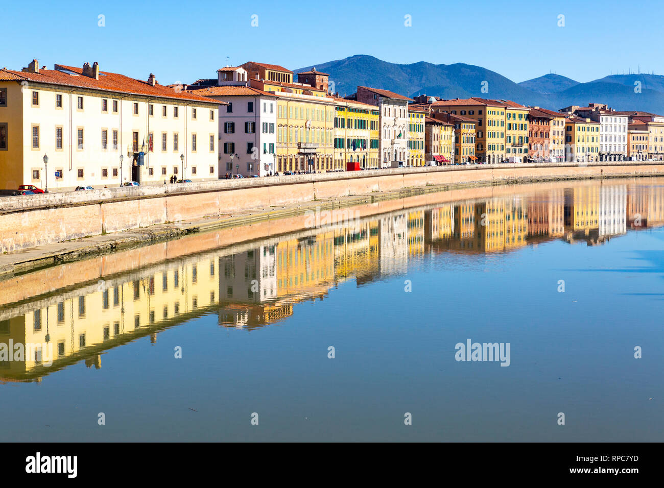 Pisa city centre in Italy with buildings reflected in the Arno River Stock Photo