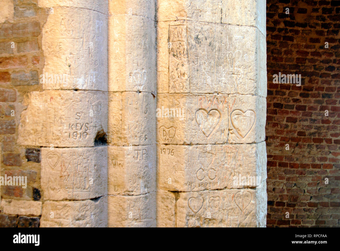 Various inscriptions carved into the ancient stonework of St Benet's Abbey, Norfolk, England. Stock Photo