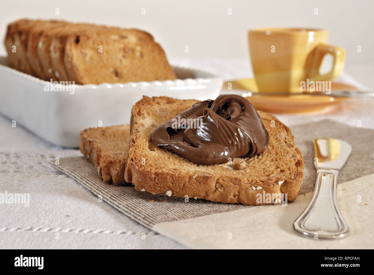fette biscottate con crema di nocciole al cacao e tazza caffè Stock Photo