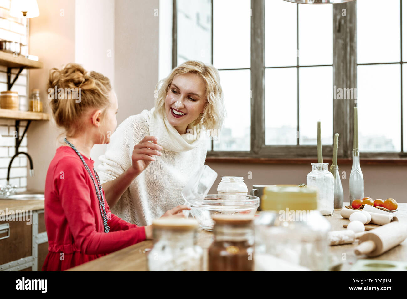 Smiling short-haired lady having face covered in baking flour Stock Photo