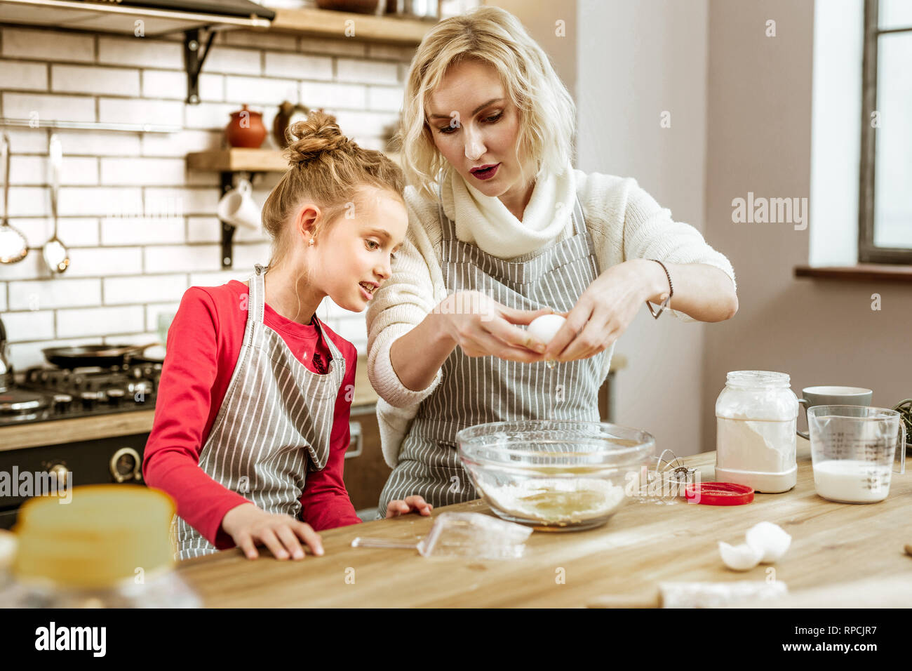 Peaceful attractive lady showing professional way of cooking Stock Photo