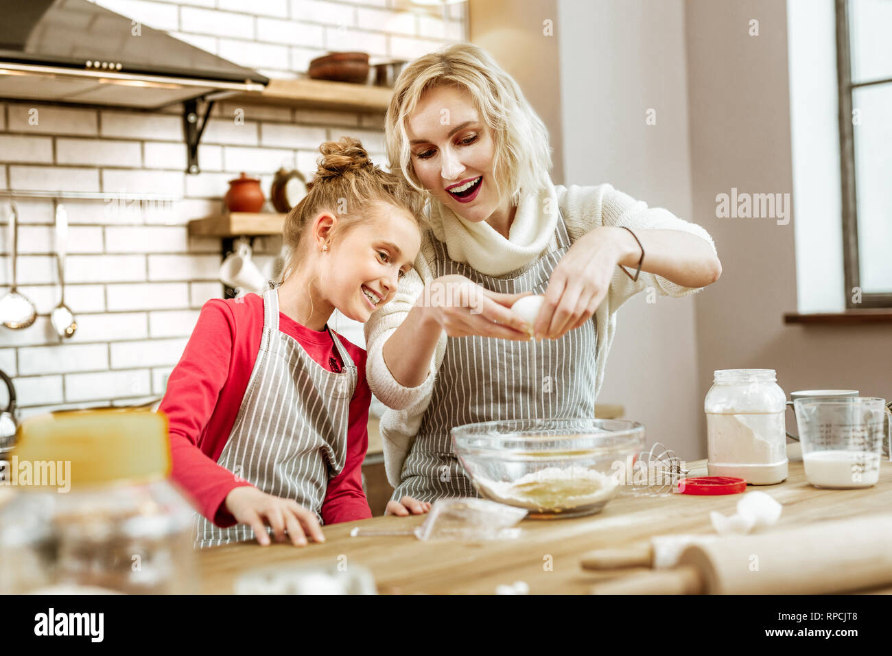 Amused mother being happy with interest of her daughter Stock Photo