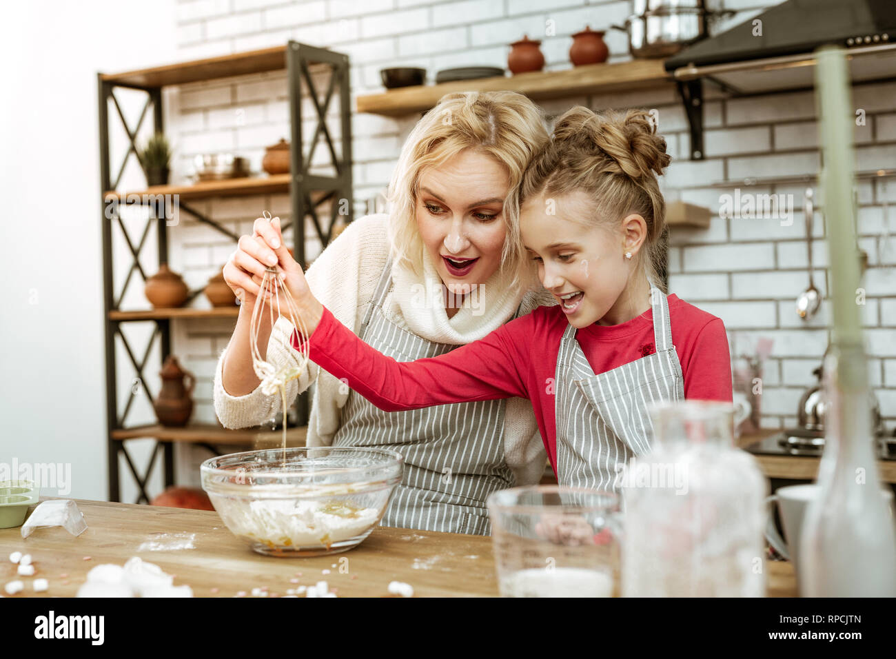 Short-haired good-looking mother being amused with time spending Stock Photo