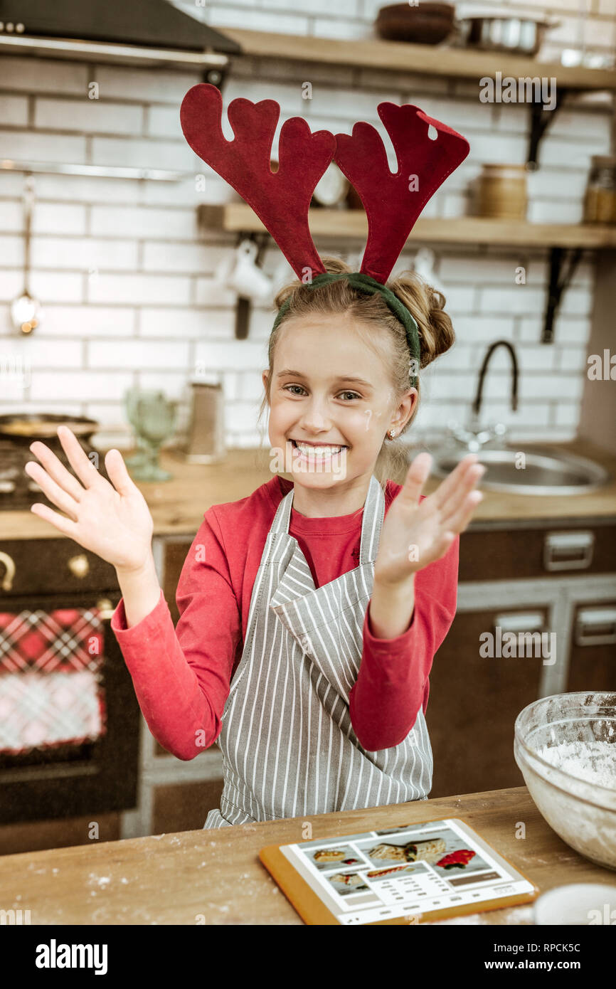 Smiling beaming woman wearing red dress and striped apron Stock Photo