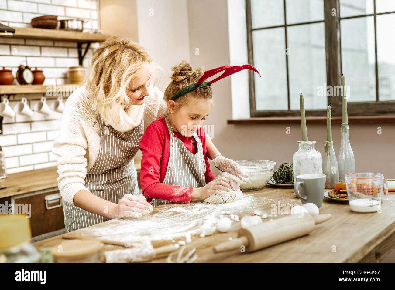 Couple of working women having kitchen covered in flour Stock Photo