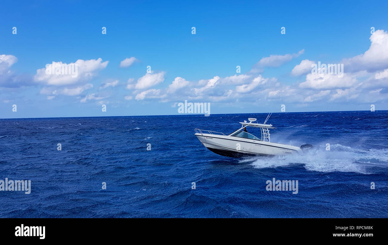 17 January 2018 - Nassau, Bahamas. Boston whaler boat jumping the waves in the sea and cruising the blue ocean day in Bahamas. Blue beautiful water Stock Photo